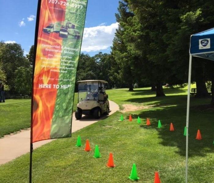 This image shows a golf cart and our SERVPRO flag at a recent golf tournament