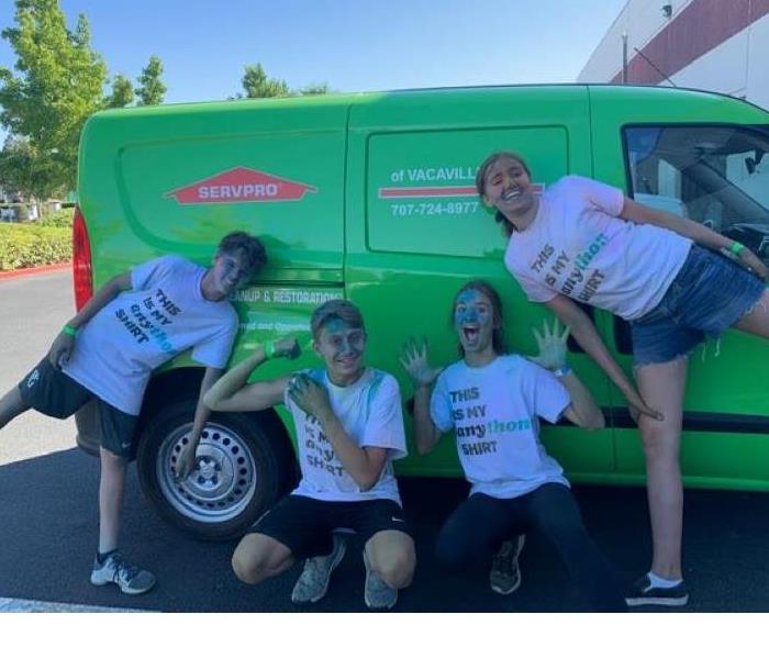 This photo shows 4 teenagers full of chalk after their Fun Run at school