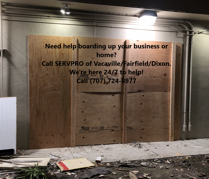 Picture shows a business boarded up with a description of our company services written on it.