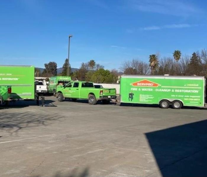 Photo shows a parking lot with SERVPRO trucks in it